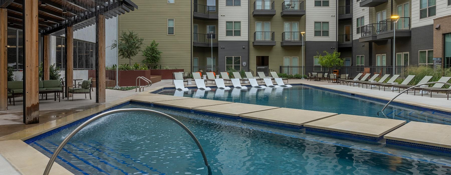 a swimming pool with chairs